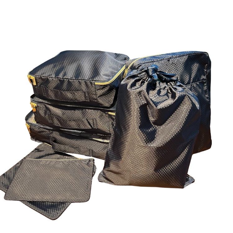 Black 7‑in‑1 suitcase organizer packed in a carry‑on